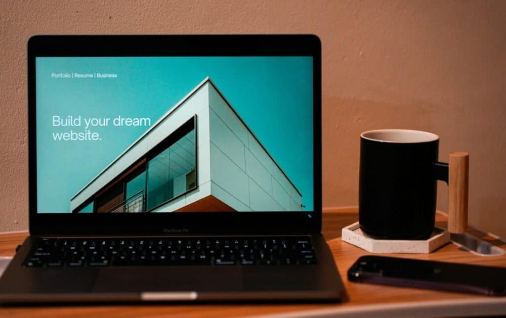 Build your dream website modern architecture facade on laptop.