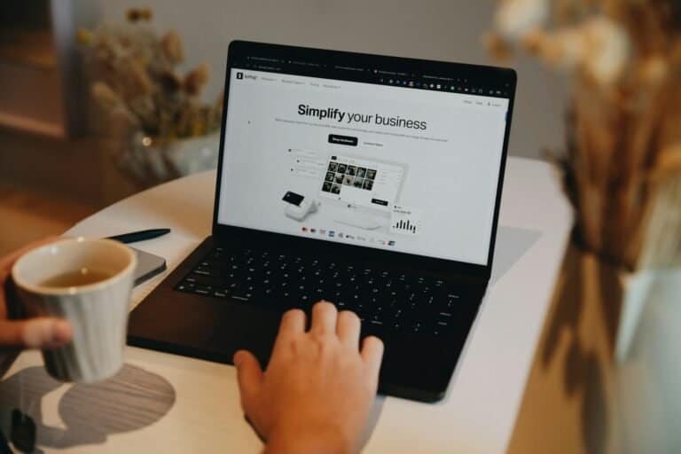 Tecnologia para negócios, laptop com site de vendas, digitalização, soluções empresariais, inovação digital.