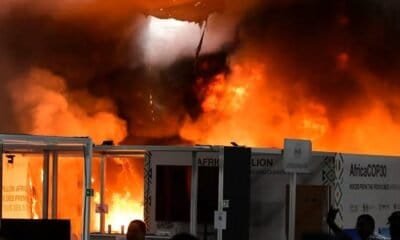 Incêndio em evento com estrutura de feira, grande chame e fumaça de fogo intenso.