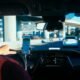 Pessoa usando smartphone no carro, tecnologia de condução autônoma em destaque.