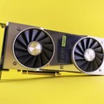 Close-up of a RTX 2080 Super graphics card against a bright yellow backdrop, showcasing high-tech design.