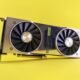 Close-up of a RTX 2080 Super graphics card against a bright yellow backdrop, showcasing high-tech design.